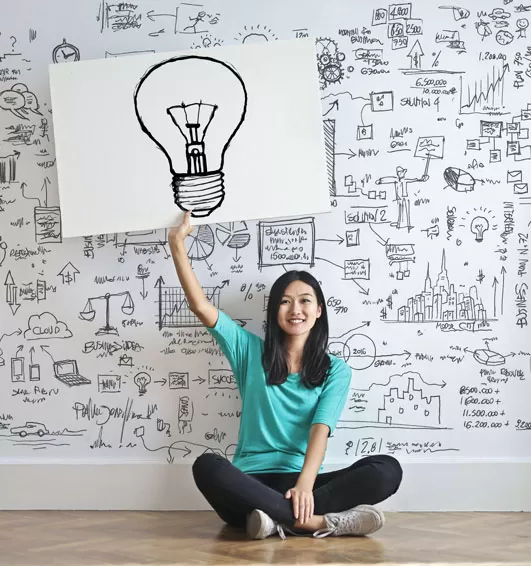 woman holding up lightbulb image