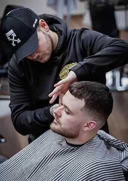 Barber in custom hoodie uniform