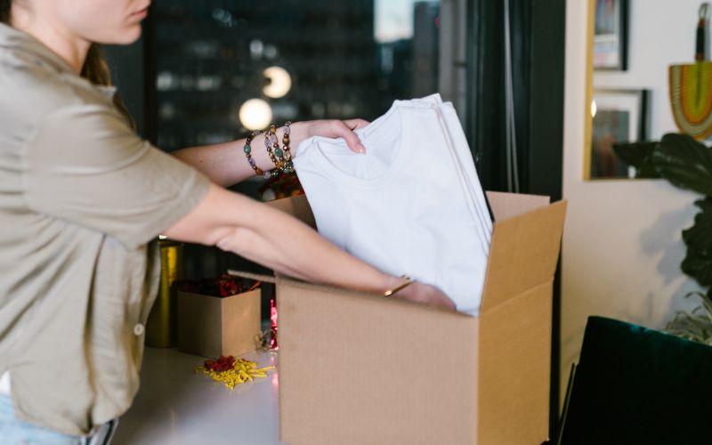 Putting T-shirts into stock boxes.