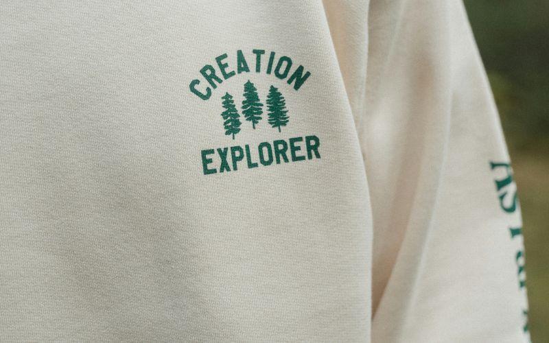 Custom hoodie featuring the Creation Explorer logo on the chest and another logo on the sleeve.