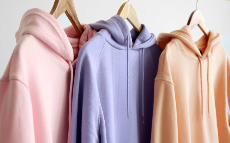 A collection of pastel hoodies arranged for custom logo printing.