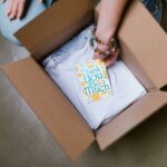 Packaging a T-shirt merch order.